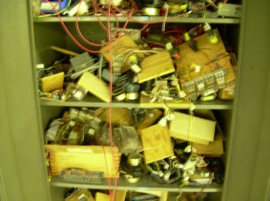 Cabinet full of parts in room full of cabinets