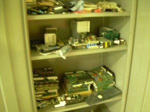 Cabinet of parts in room full of cabinets